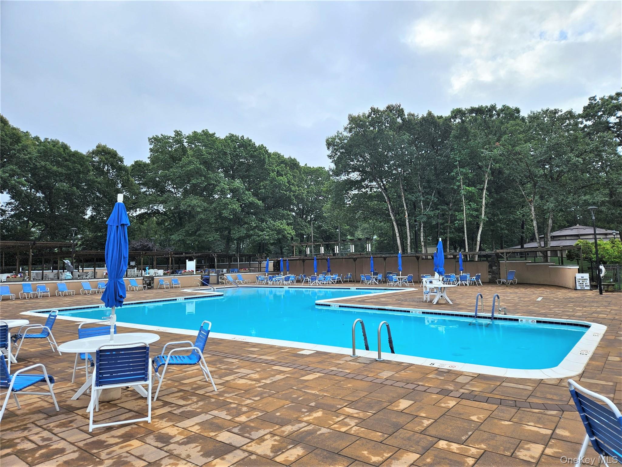 186 C Ventry Court Ridge, NY 11961 - Photo 23 of 25 a view of a swimming pool with sitting area