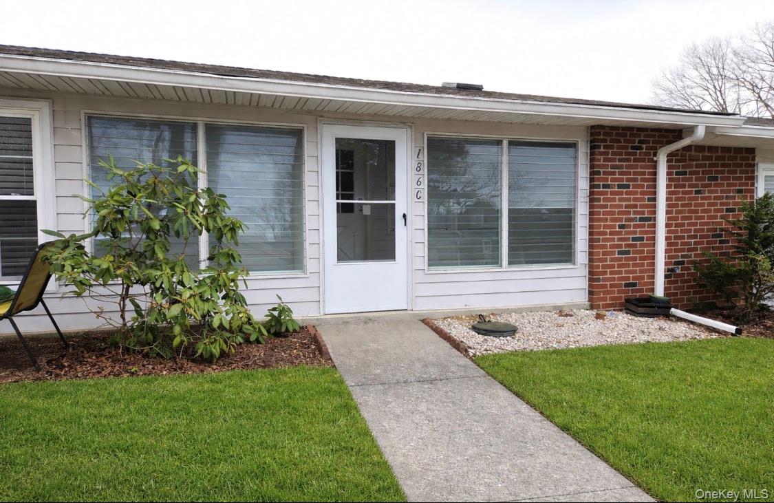 186 C Ventry Court Ridge, NY 11961 - Photo 3 of 25 a front view of a house with a garden