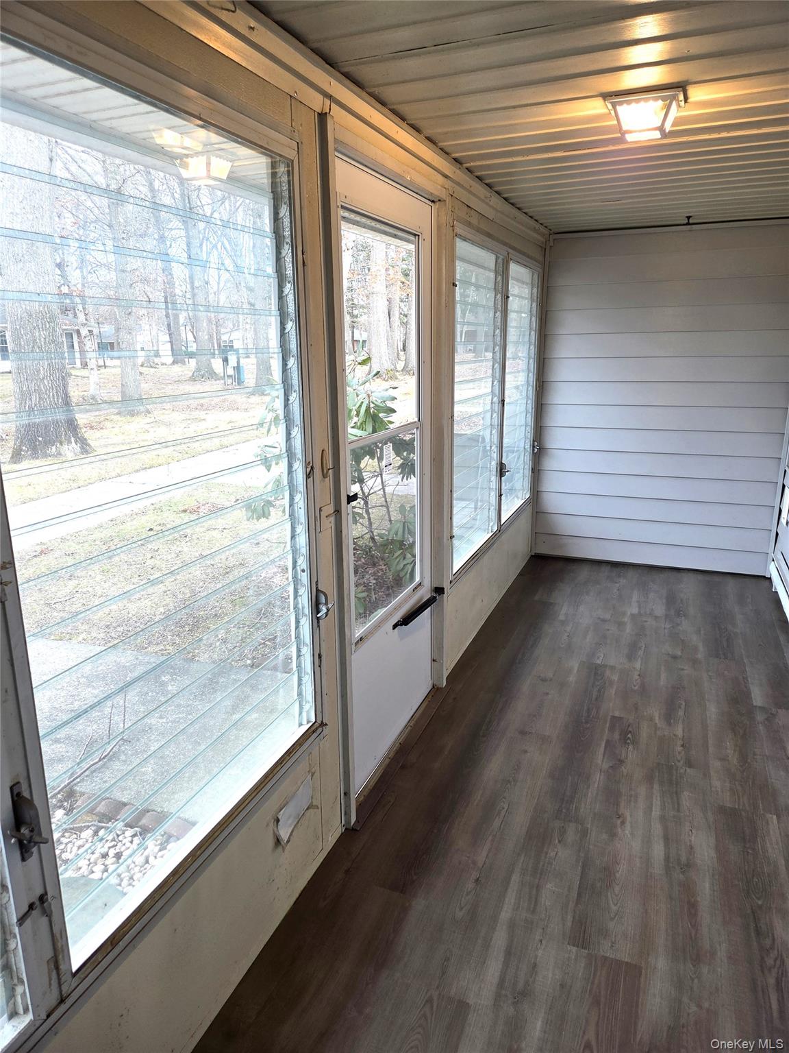 186 C Ventry Court Ridge, NY 11961 - Photo 5 of 25 a view of an empty room and wooden floor and a window