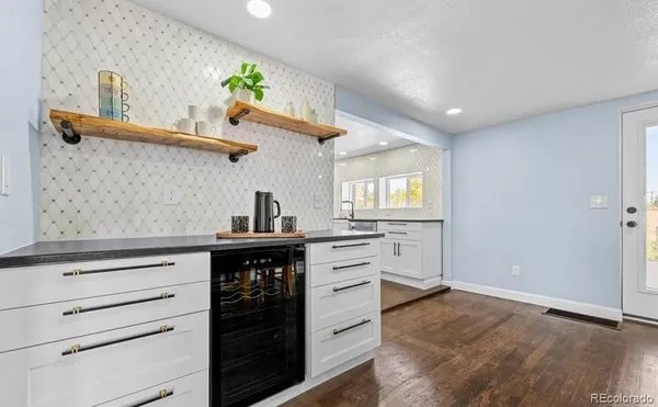 a kitchen with a stove cabinets and wooden floor