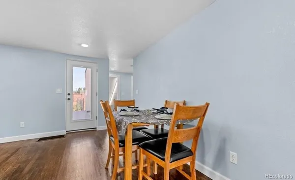 a view of a dining room with furniture and wooden floor