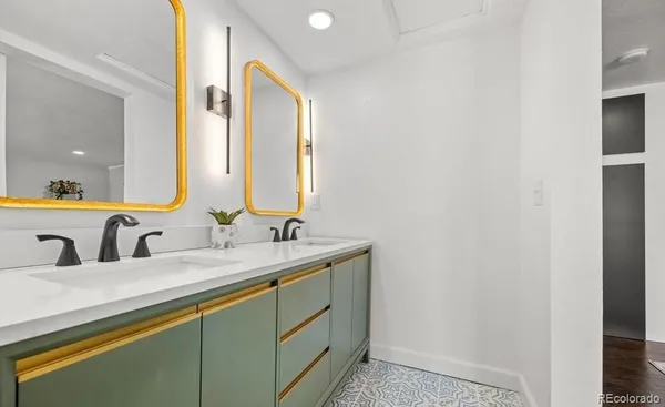 a bathroom with a double vanity sink and mirror
