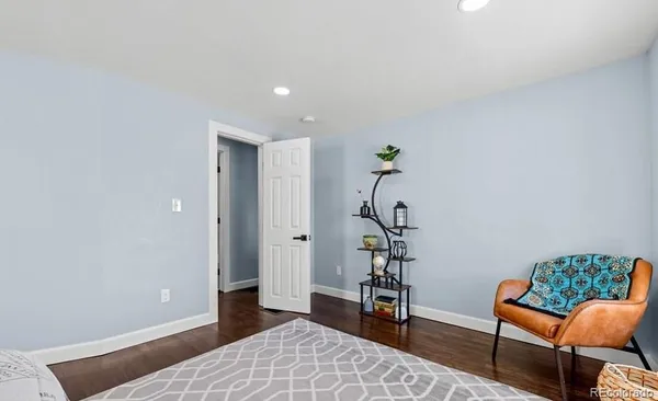 a bedroom with furniture and a potted plant