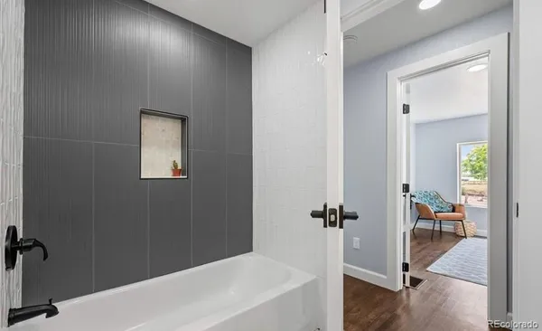 a bathroom with a bathtub and a shower