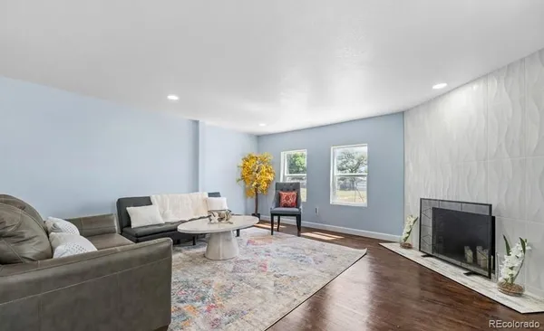 a living room with furniture a window and a fireplace