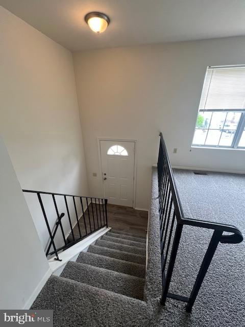 3801 8th Street North Beach, MD 20714 - Photo 11 of 13 a view of staircase with lots of frames on wall and a window