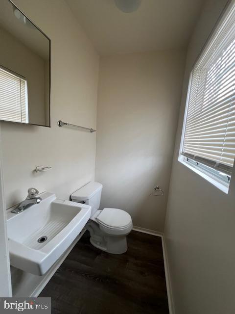 3801 8th Street North Beach, MD 20714 - Photo 6 of 13 a bathroom with a sink toilet and mirror
