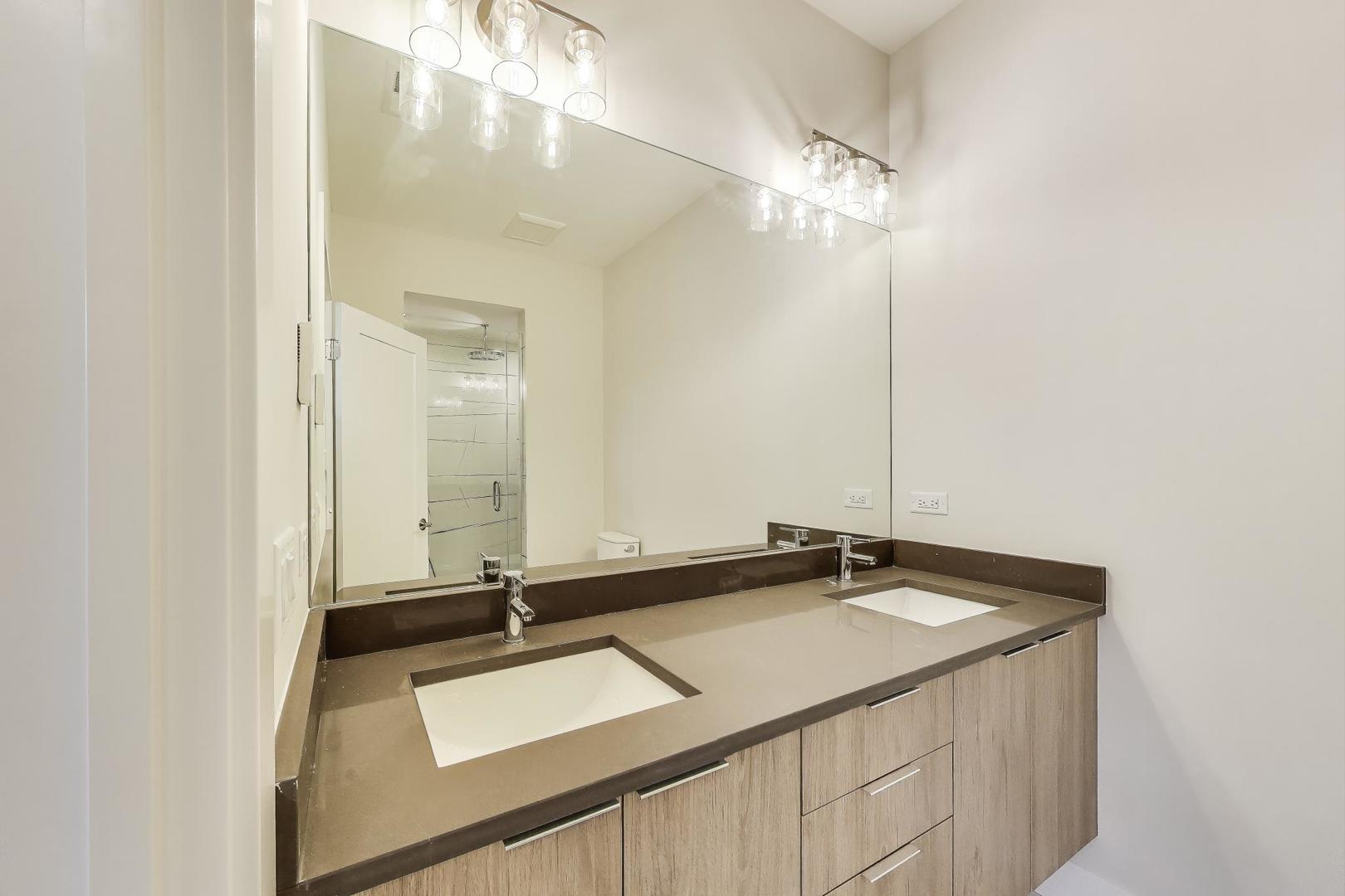 3339 North Ridgeway Avenue, Unit 1S Chicago, IL 60618 - Photo 11 of 20 a bathroom with a sink and a mirror
