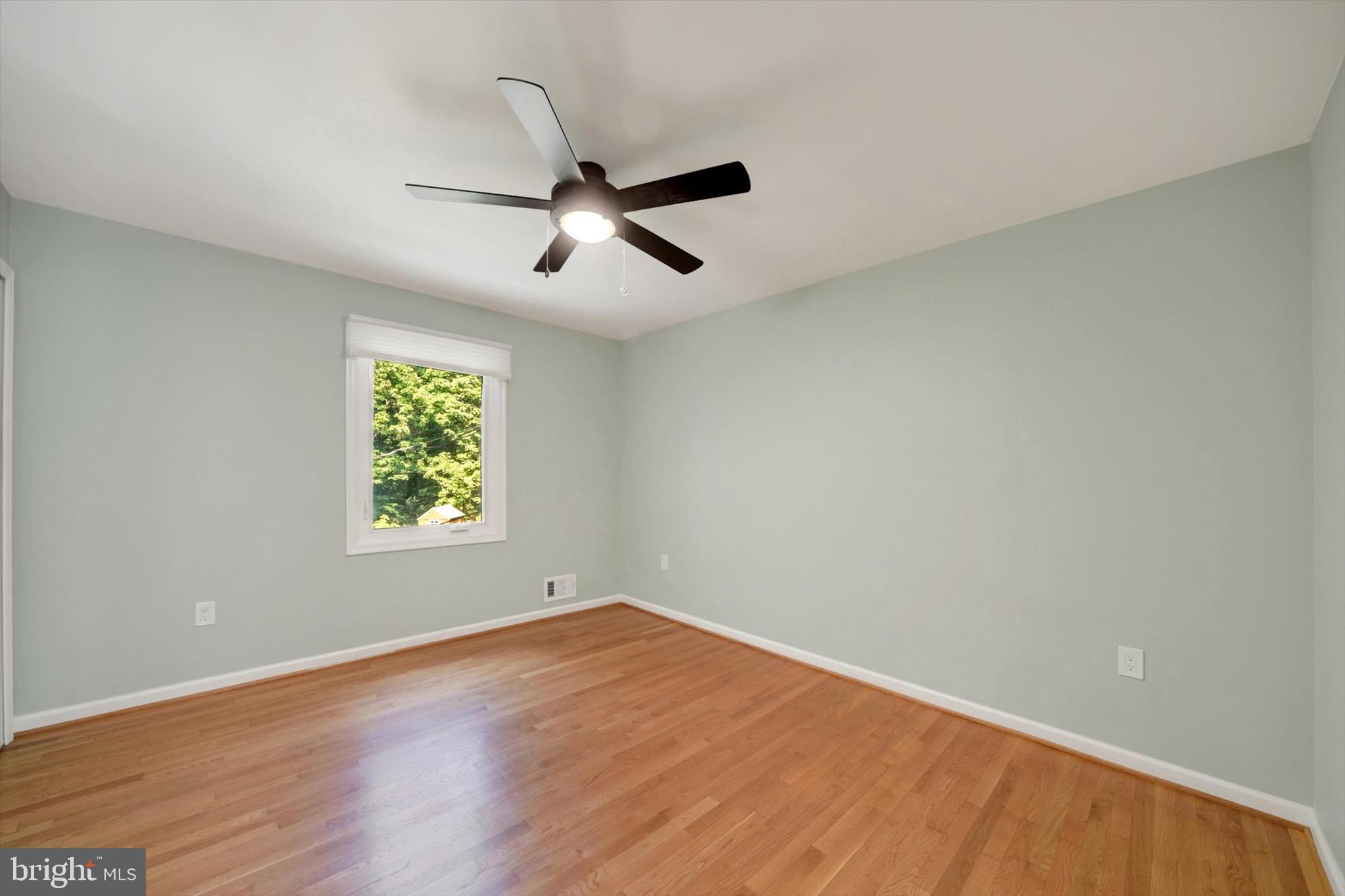 900 Stags Head Road Towson, MD 21286 - Photo 27 of 83 wooden floor in an empty room with a window