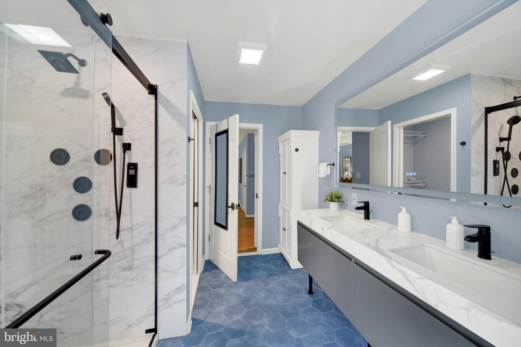 900 Stags Head Road Towson, MD 21286 - Photo 35 of 83 a bathroom with a double vanity sink a mirror a shower and a bathtub