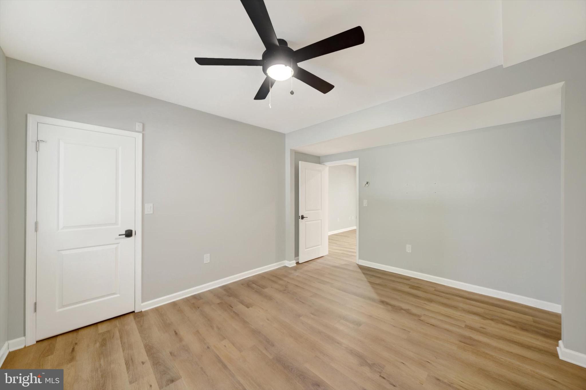 900 Stags Head Road Towson, MD 21286 - Photo 41 of 83 an empty room with wooden floor and a ceiling fan