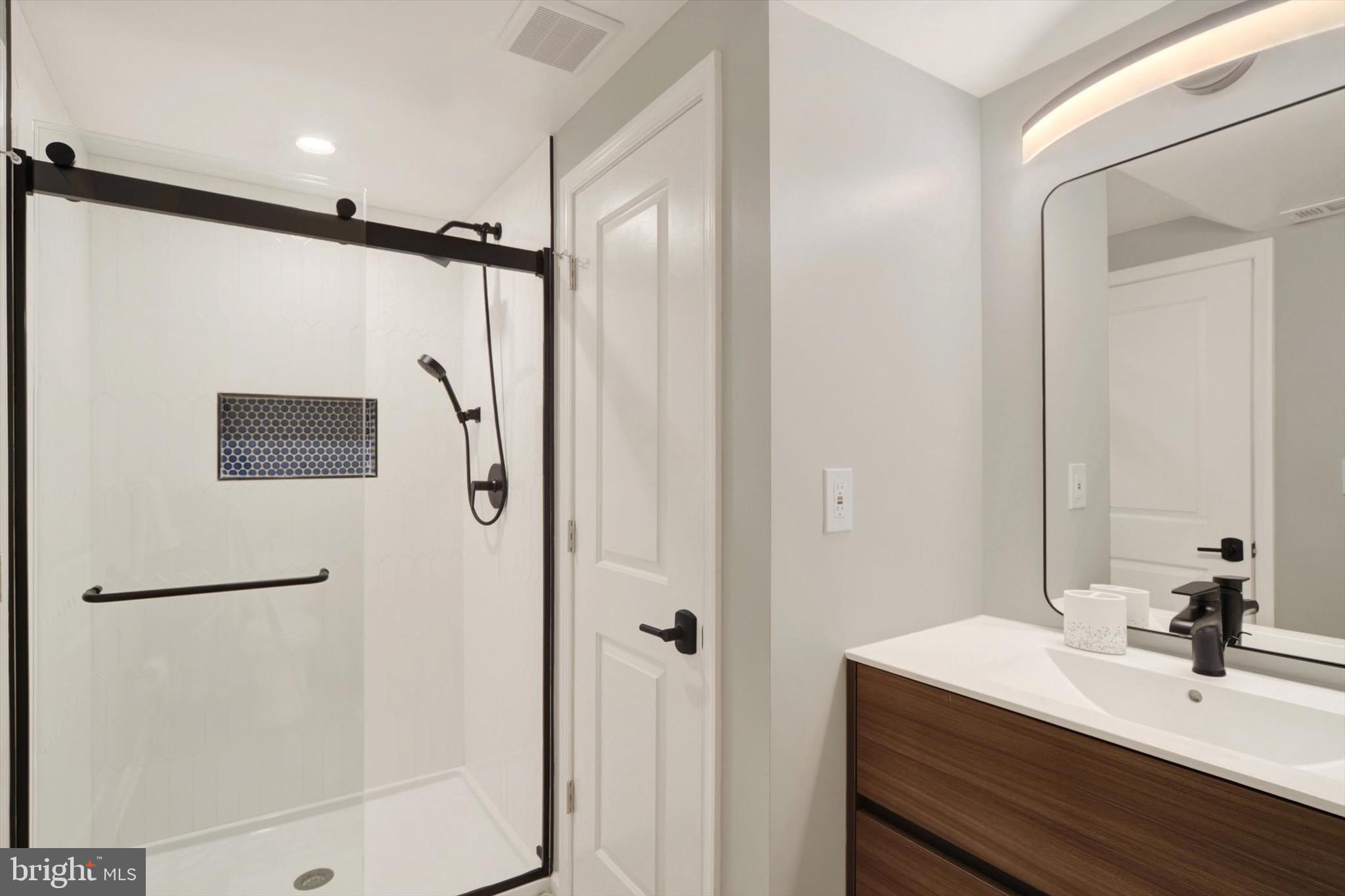 900 Stags Head Road Towson, MD 21286 - Photo 49 of 83 a bathroom with a shower sink and mirror