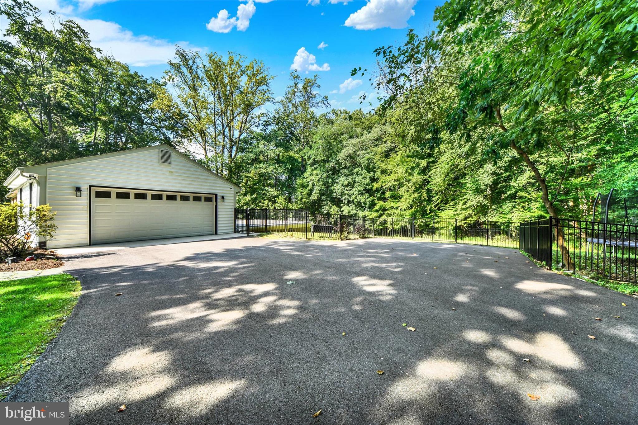 900 Stags Head Road Towson, MD 21286 - Photo 66 of 83 a front view of a house with a yard and a garage