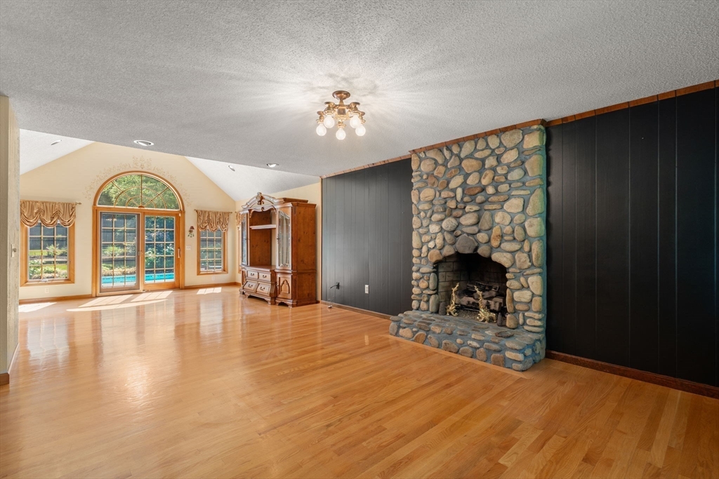 2035 Parker Street Springfield, MA 01128 - Photo 8 of 42 a view of empty room with fireplace and wooden floor