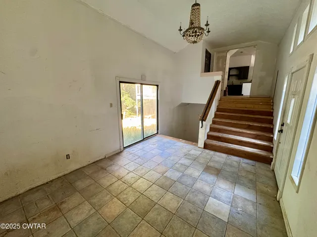 a kitchen with granite countertop a sink a stove and cabinets