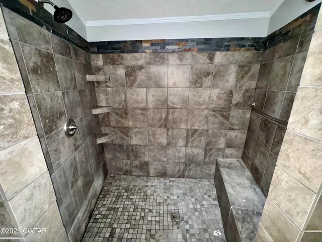 a bathroom with a double vanity sink a mirror and a bathtub