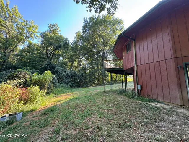 a view of a backyard with plants and a patio