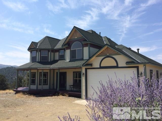 21475 Saddleback Road Reno, NV 89521 - Photo 1 of 1 a front view of a house with a yard and garage