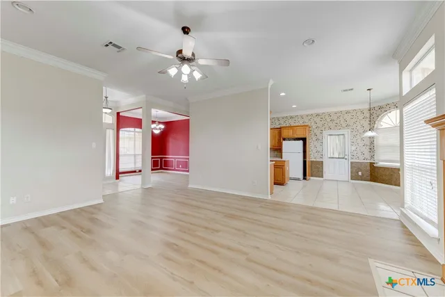 an empty room with wooden floor and entryway