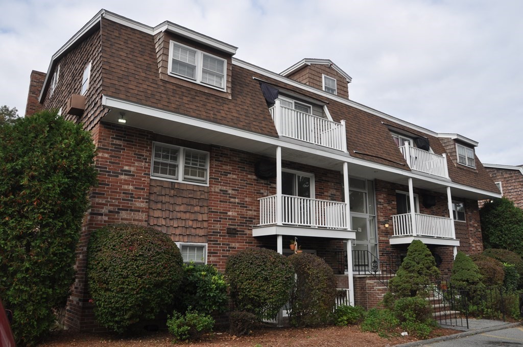a front view of a house with plants