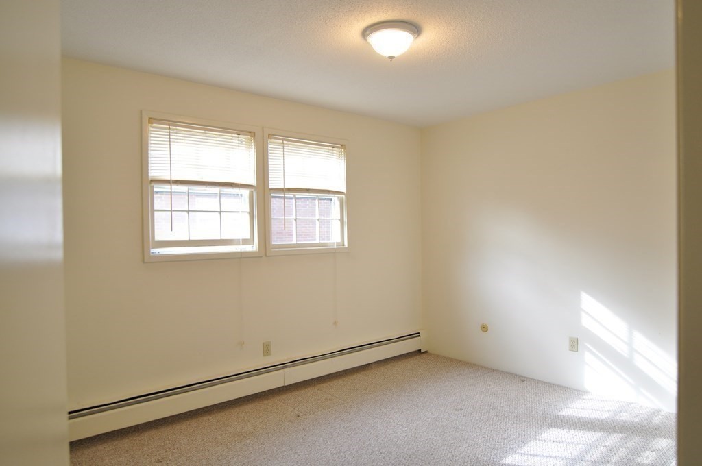 90 Beacon Street, Unit 8 Lawrence, MA 01843 - Photo 13 of 26 an empty room with windows