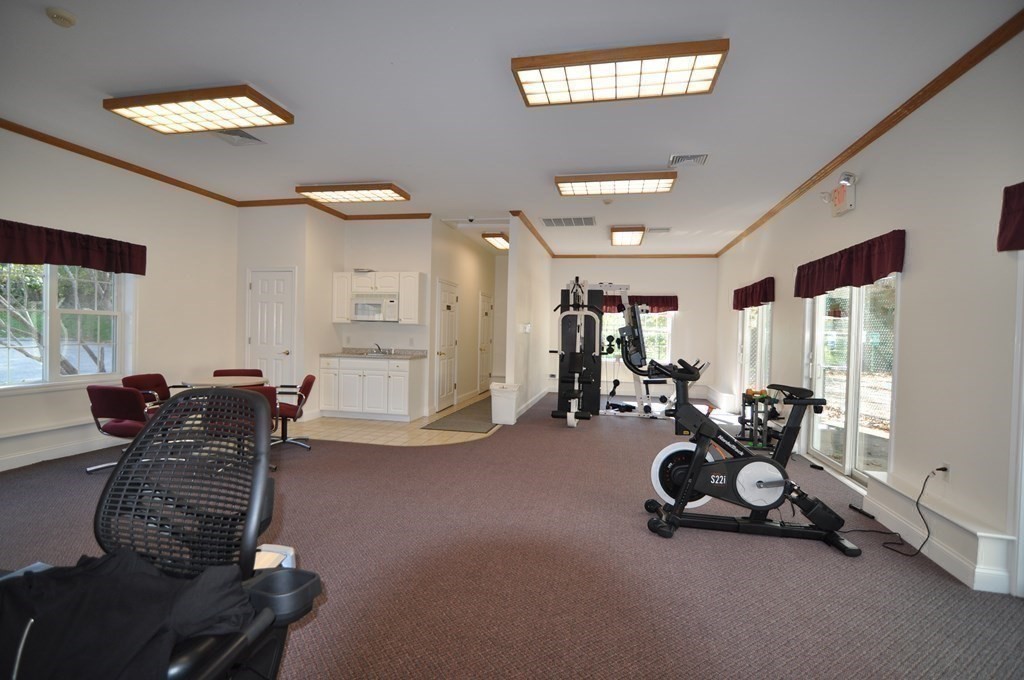 90 Beacon Street, Unit 8 Lawrence, MA 01843 - Photo 20 of 26 a room with gym equipment and windows