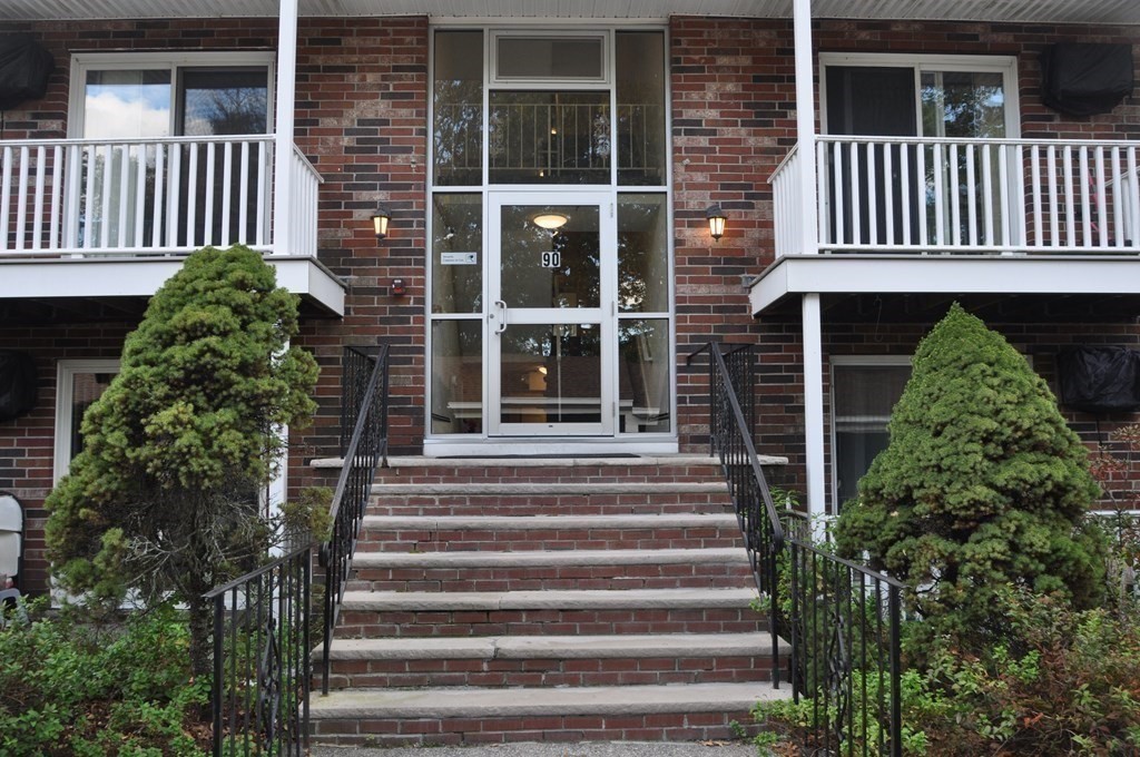 90 Beacon Street, Unit 8 Lawrence, MA 01843 - Photo 2 of 26 a view of a house with a window and flower plants