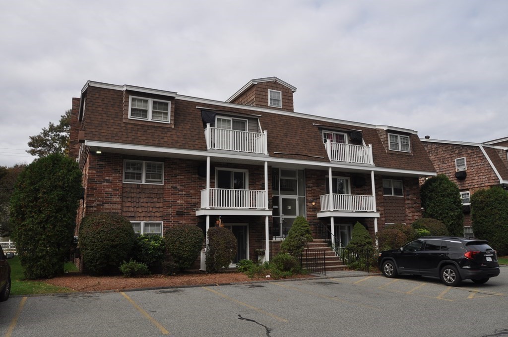 90 Beacon Street, Unit 8 Lawrence, MA 01843 - Photo 3 of 26 a front view of a house with a yard