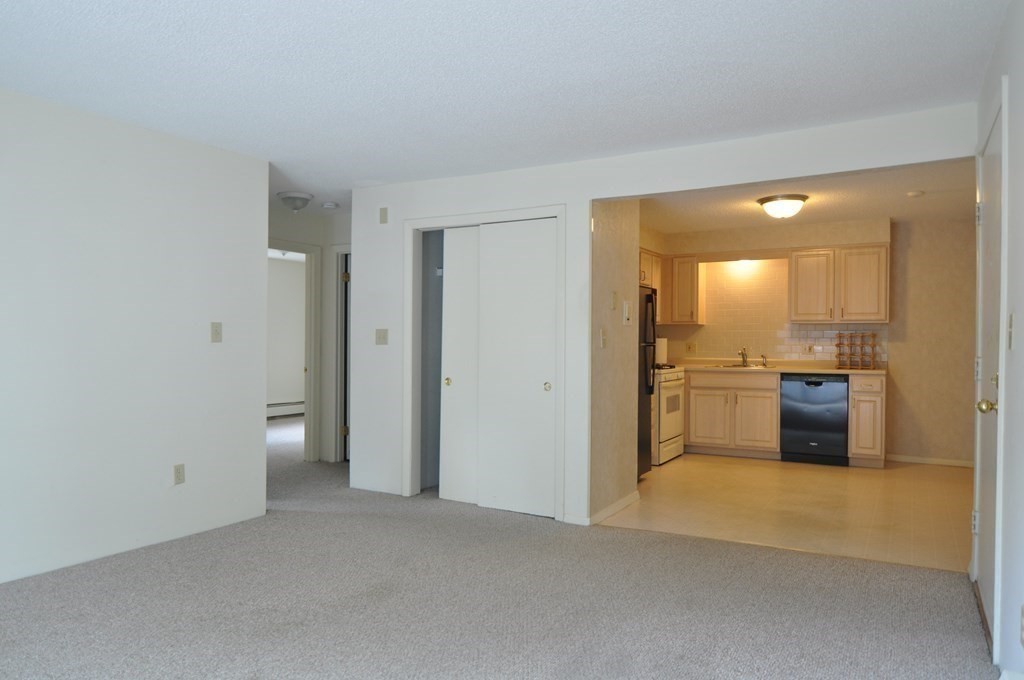 90 Beacon Street, Unit 8 Lawrence, MA 01843 - Photo 8 of 26 a view of a kitchen cabinets and wooden floor