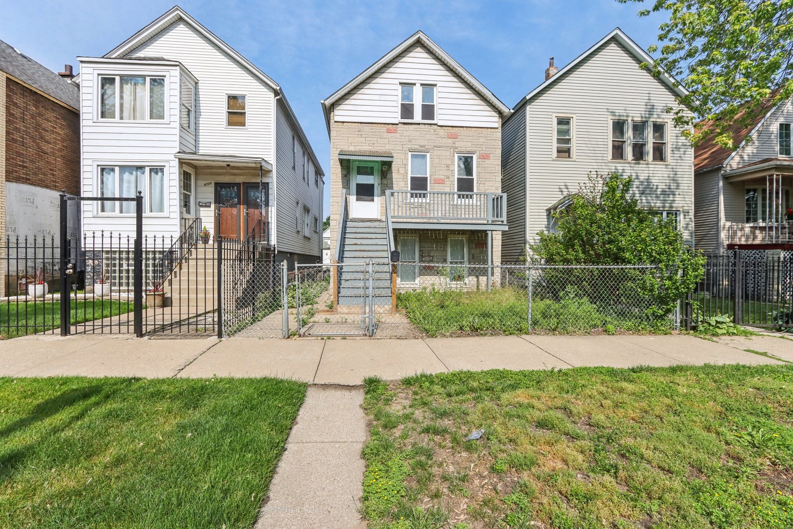 9720 South Exchange Avenue Chicago, IL 60617 - Photo 1 of 17 a front view of a house with a garden and plants