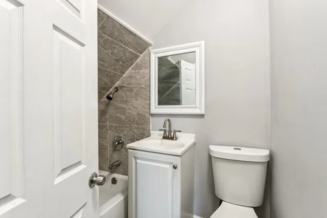 a bathroom with a sink toilet and a mirror