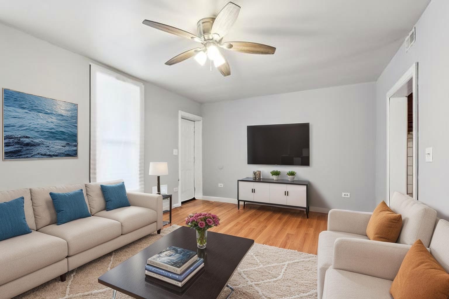 9720 South Exchange Avenue Chicago, IL 60617 - Photo 12 of 17 a living room with furniture and a flat screen tv