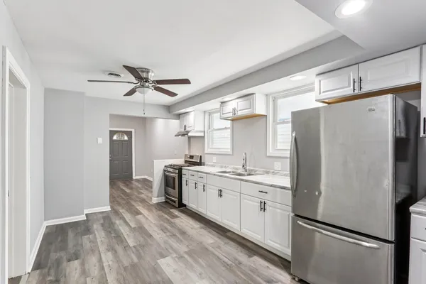 a kitchen with stainless steel appliances a refrigerator sink and stove
