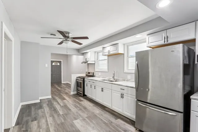 a kitchen with stainless steel appliances a refrigerator sink and stove