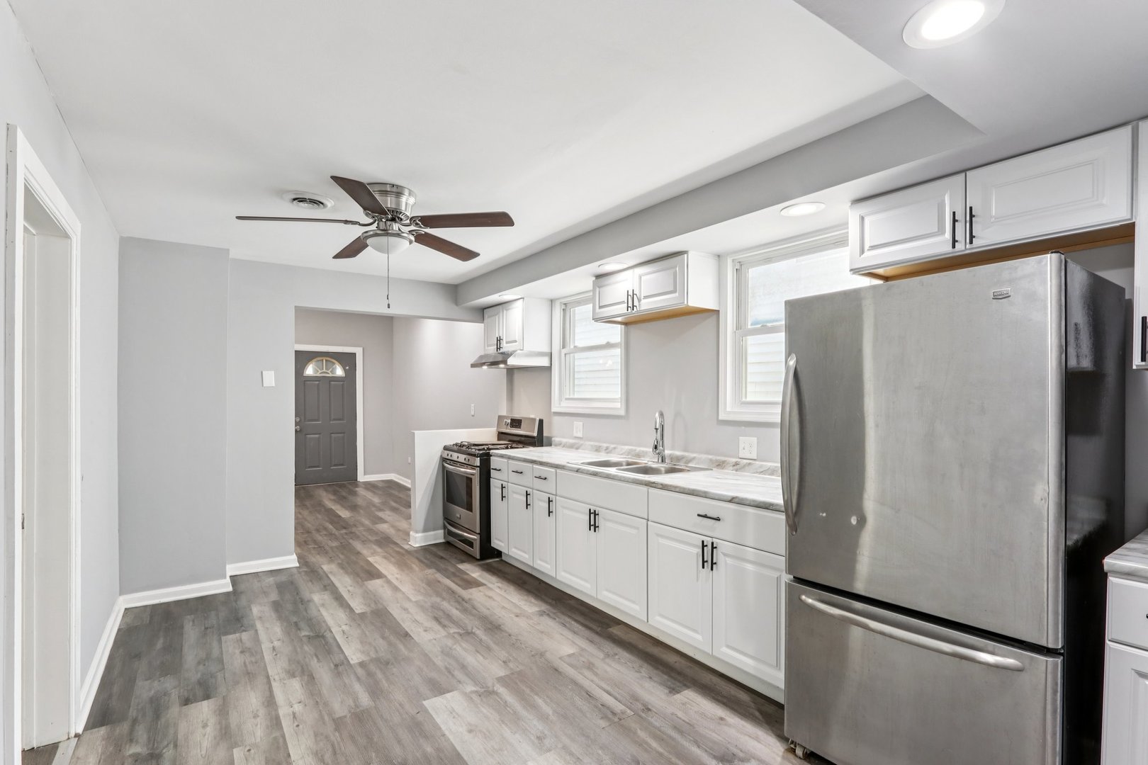 9720 South Exchange Avenue Chicago, IL 60617 - Photo 3 of 17 a kitchen with stainless steel appliances a refrigerator sink and stove