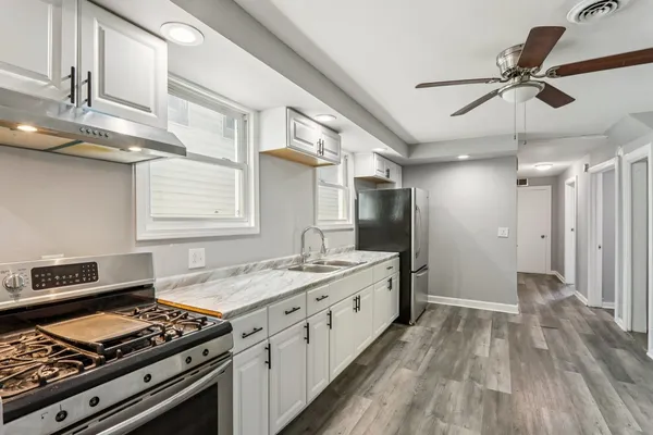 a kitchen with stainless steel appliances granite countertop a stove and a refrigerator