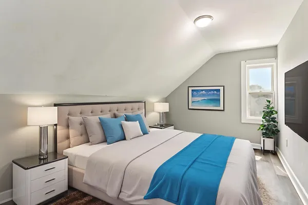 a bedroom with bed and a night stand
