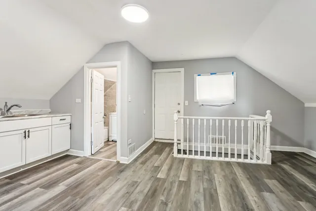 a view of a livingroom with wooden floor and a window