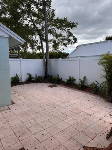 a view of a patio with table and chairs and potted plants