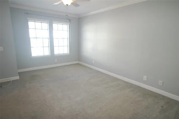 an empty room with windows and closet