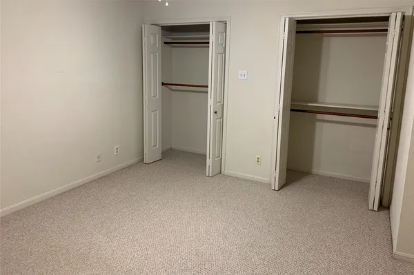 an empty room with closet area