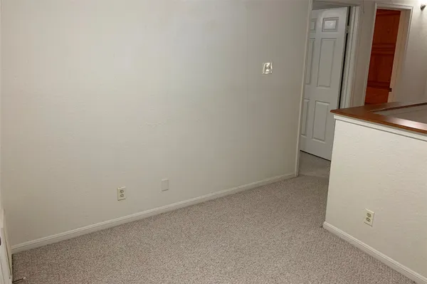 a front view of a house with a tree