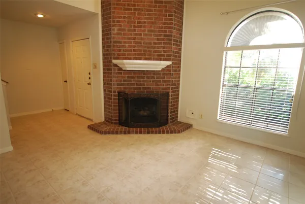 a view of empty room with a fireplace