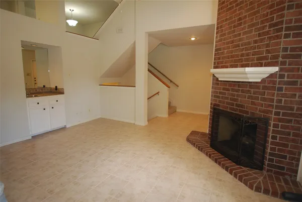 a view of an empty room and fire place