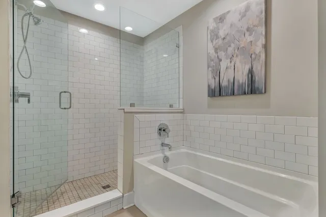 a bathroom with a bathtub and shower