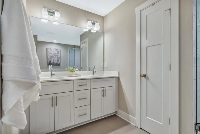 a bathroom with a double vanity sink and a mirror
