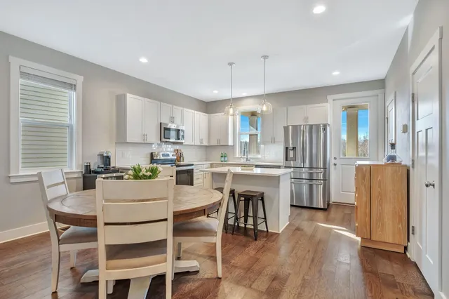 a kitchen with white cabinets and stainless steel appliances