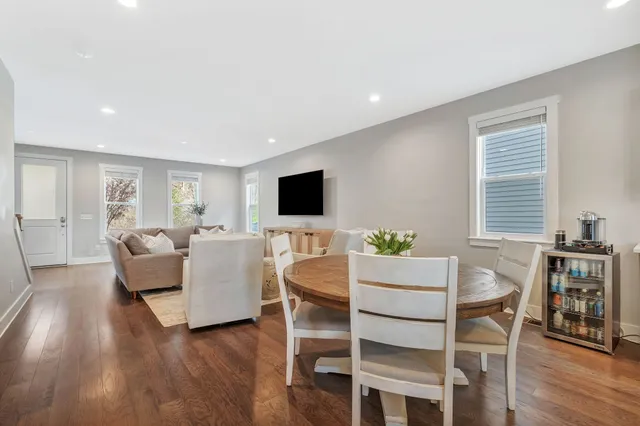 a dining room with furniture and wooden floor