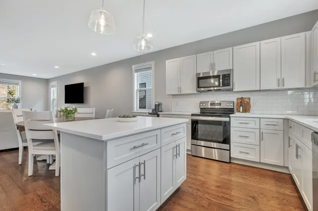 a kitchen with appliances a sink and cabinets