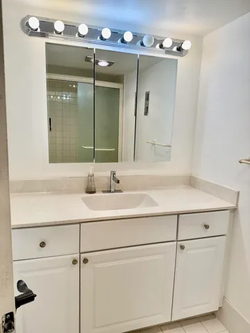 a bathroom with a sink vanity and mirror